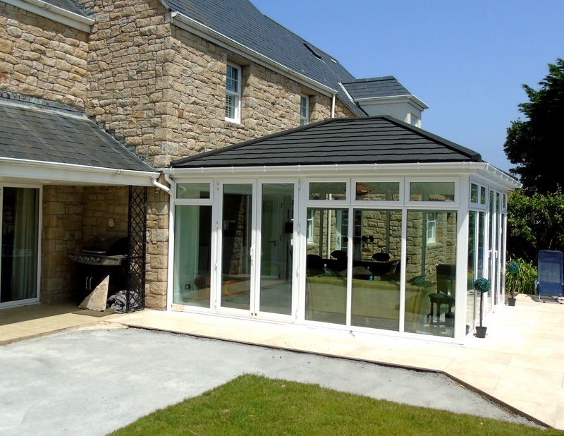 Grey Supalite roof conservatory with Extralight tiles