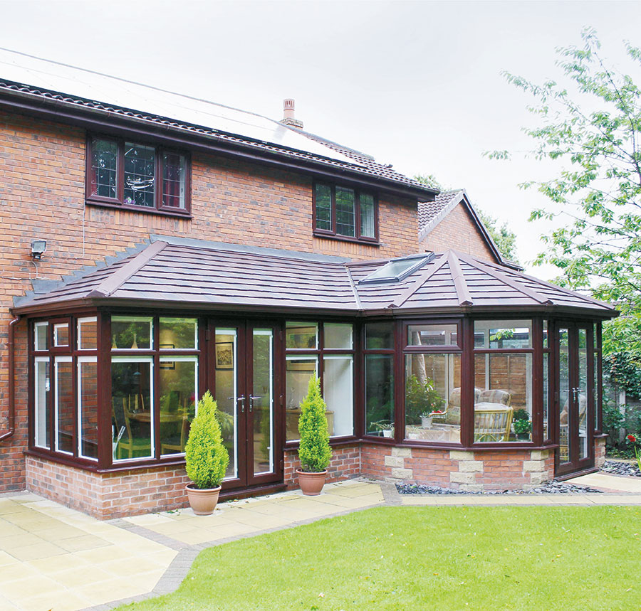 Brown tiled roof conservatory with trees